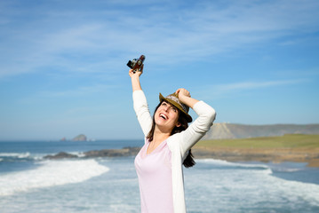 Happy woman enjoying freedom towards the sea