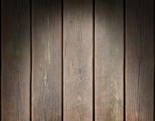 Weathered wooden plank background lit from above