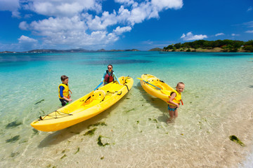 Family kayaking at tropical ocean