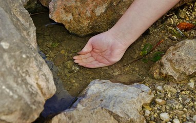 Beautiful woman hand on water