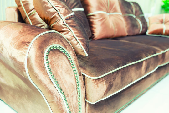 Velvet pillows on the brown sofa