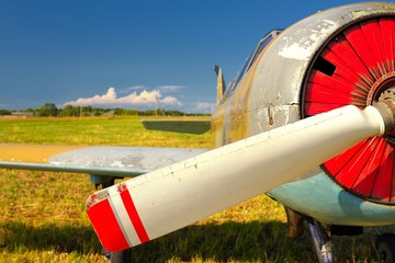 Old russian airplane on green grass