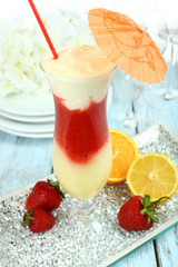 Delicious fruit smoothie on wooden table, close up