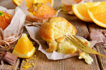 Tasty cupcakes with orange on table close-up
