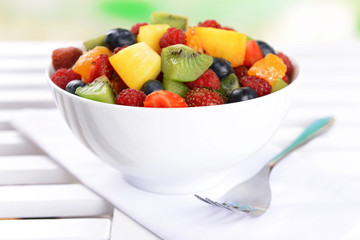 Delicious fruits salad in plate on table close-up
