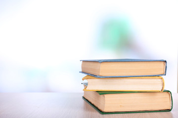 Books on wooden table on natural background