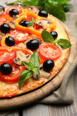 Delicious pizza served on wooden table