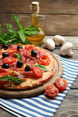 Delicious pizza served on wooden table