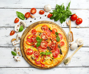 Delicious pizza served on wooden table