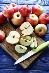 Juicy apples on wooden table, close-up