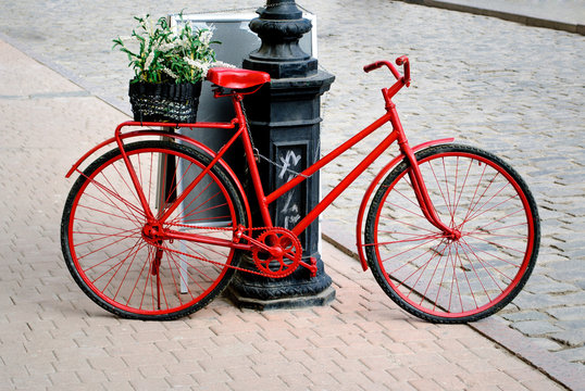 Fototapeta a bicycle is red with the small basket of colors