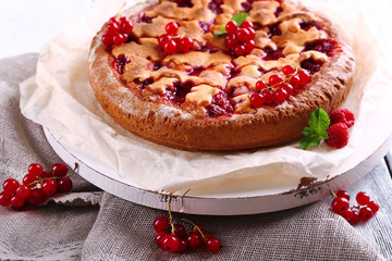 Tasty cake with berries on table close-up
