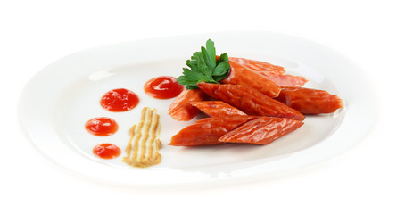 Smoked thin sausages and vegetables on plate, isolated on white