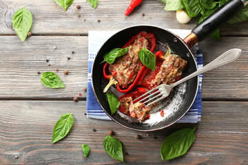 Delicious stuffed peppers in frying pan on table close-up