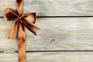 Old wooden background with beautiful bow