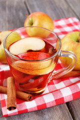 Apple cider with cinnamon sticks and fresh apples