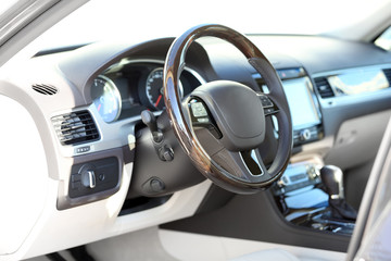 Interior view of car with beige salon and black dashboard