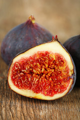 Ripe sweet figs on wooden background