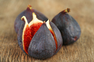 Ripe sweet figs on wooden background