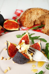 Ripe sweet fig with cottage cheese and honey, on plate