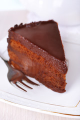 Piece of chocolate cake on plate closeup