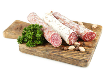 Italian salami on wooden cutting board, isolated on white
