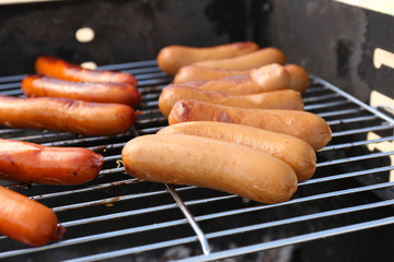 Sausages on barbecue grill, close-up