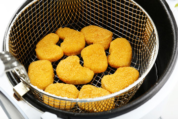 Cutlets in deep fryer, closeup