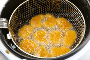 Cutlets in deep fryer, closeup