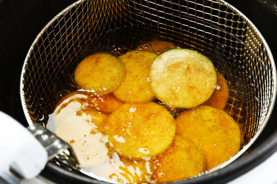 Zucchini in deep fryer, closeup