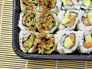 Tightly packed sushi rolls on platter