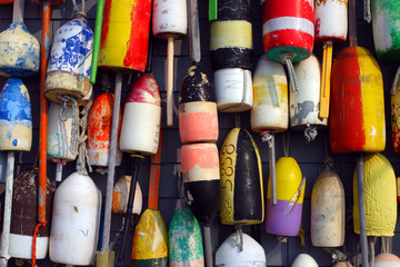 Buoys on the side of a beach shack ..