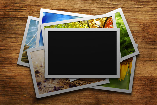 Pile of colorful photos with blank frame