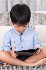 boy playing with digital tablet