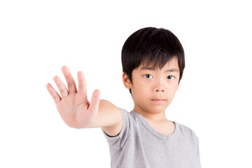 Portrait of a young boy making stop gesture on white background
