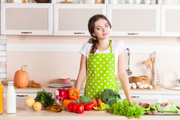 Young Woman Cooking in the kitchen. Healthy Food. Dieting Concep