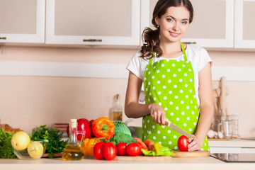 Young Woman Cooking in the kitchen. Healthy Food. Dieting Concep