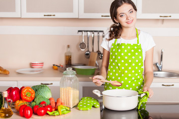 Young Woman Cooking in the kitchen. Healthy Food. Dieting Concep
