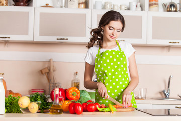 Young Woman Cooking in the kitchen. Healthy Food. Dieting Concep