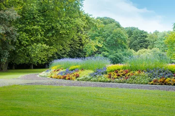 Rolgordijnen summer park with beautiful flowerbeds © alinamd
