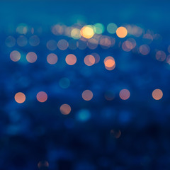 city blurring lights abstract circular bokeh blue background wit