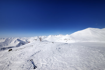 Fototapeta na wymiar Ski poles on snow slope at nice day