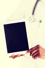 Smiling doctor using a tablet computer