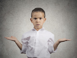 clueless child boy with arms out asking what's problem