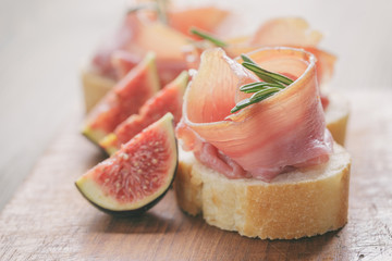 canapes with jamon and figs on table