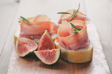 canapes with jamon and figs on table