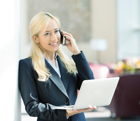 businesswoman working on computer calling on phone