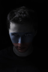 serios man face with painted flag colors of Russia