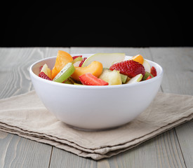 fresh mix fruit salad with strawberry, kiwi and peach