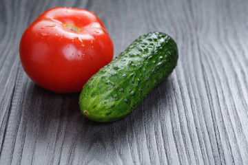 tomato and cucumber on black wood table